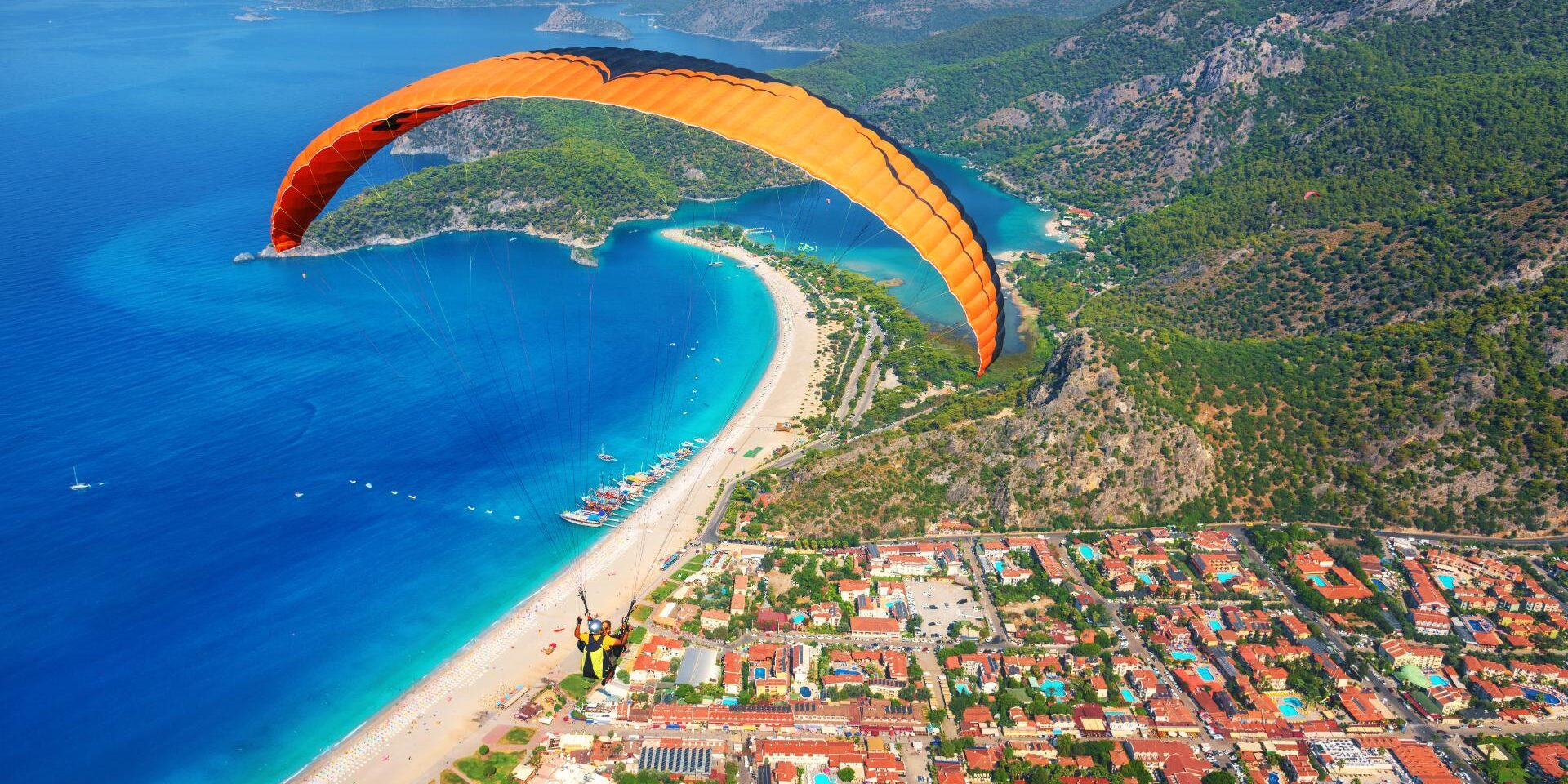 paraglider-tandem-flying-over-the-sea-with-blue-wa-2024-11-28-03-28-46-utc