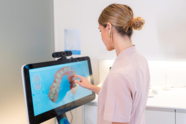 dentist-looking-at-3d-x-ray-on-client-s-monitor-in-2024-12-10-00-36-48-utc (1)